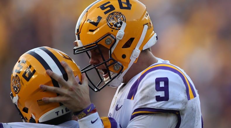 LSU quarterback Joe Burrow celebrates with a teammate during Oct. 26, 2019, matchup against the Auburn Tigers at Tiger Stadium in Baton Rouge, La.