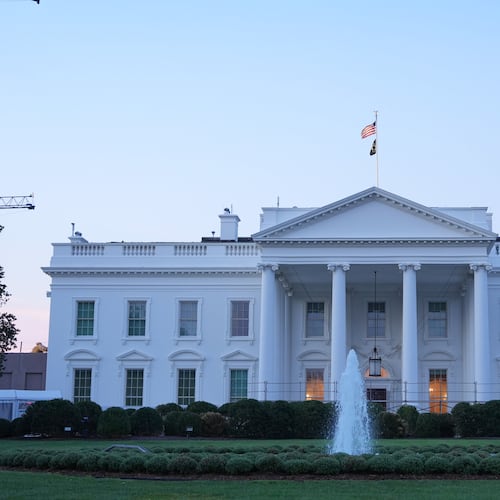 A worker waters plants on the North Lawn of the White House Monday, Sept. 21, 2026, in Washington. (AP Photo/Mark Schiefelbein)