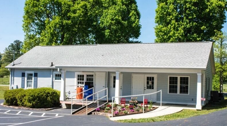 Timothy’s Cupboard, a food ministry of Timothy Lutheran Church in Woodstock, is shown. The building is small and gray.