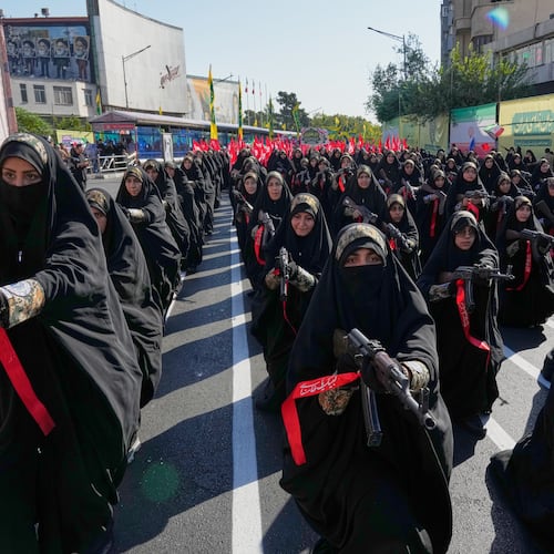 Women affiliated with Iran's Revolutionary Guard carry rifles as they stand during the state-organized "Janfada," or "Sacrifice for Iran," military-style parade in Tehran, Iran, Friday, Sept. 18, 2026. (AP Photo/Vahid Salemi)