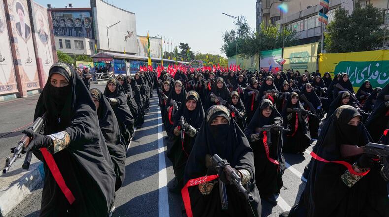 Women affiliated with Iran's Revolutionary Guard carry rifles as they stand during the state-organized "Janfada," or "Sacrifice for Iran," military-style parade in Tehran, Iran, Friday, Sept. 18, 2026. (AP Photo/Vahid Salemi)