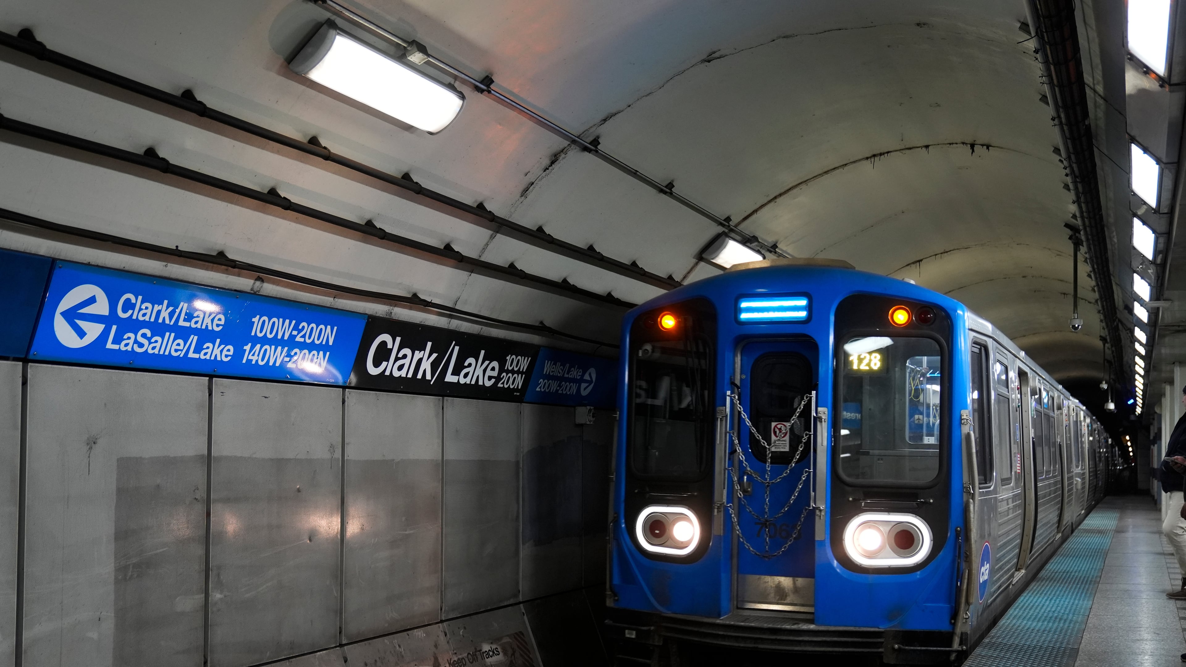 A train pulls into the Clark Street and Lake Street Blue Line stop where a man doused a woman in liquid and set her on fire on the train Monday night, Tuesday, Nov. 18, 2025, in Chicago. (AP Photo/Erin Hooley)