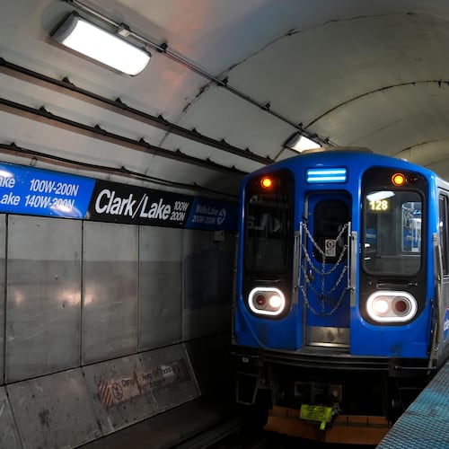 A train pulls into the Clark Street and Lake Street Blue Line stop where a man doused a woman in liquid and set her on fire on the train Monday night, Tuesday, Nov. 18, 2025, in Chicago. (AP Photo/Erin Hooley)