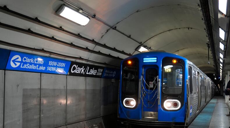 A train pulls into the Clark Street and Lake Street Blue Line stop where a man doused a woman in liquid and set her on fire on the train Monday night, Tuesday, Nov. 18, 2025, in Chicago. (AP Photo/Erin Hooley)