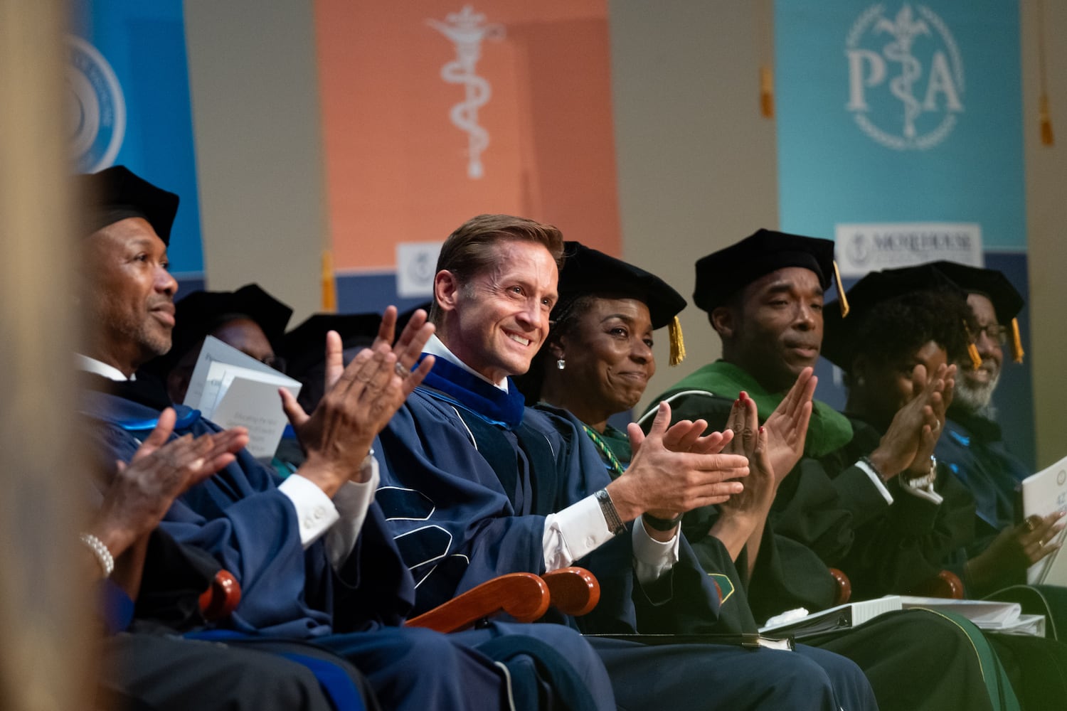 Rep. Rich McCormick, who graduated from Morehouse School of Medicine, applauds Jeromey Beaman after his remarks during the graduation ceremony on Saturday, May 16, 2026, in Atlanta. (Ben Gray for the AJC)