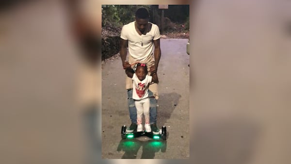 Deonta Wallace is seen giving a young family member a ride on a hoverboard. Wallace was killed in a shooting in July 2018. (Courtesy of Victor Wallace)