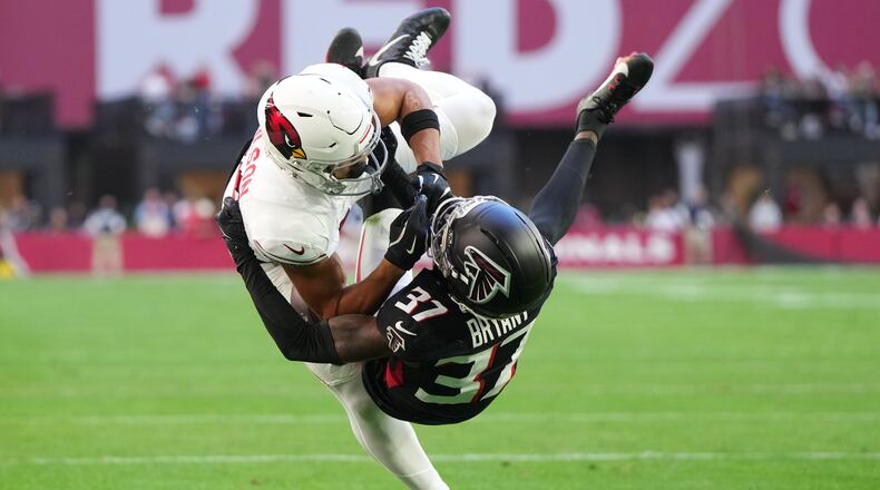Arizona Cardinals wide receiver Michael Wilson (14) scores a touchdown against Atlanta Falcons cornerback Cobee Bryant (37) during the first half of an NFL football game, Sunday, Dec. 21, 2025, in Glendale, Ariz. (AP Photo/Rick Scuteri)