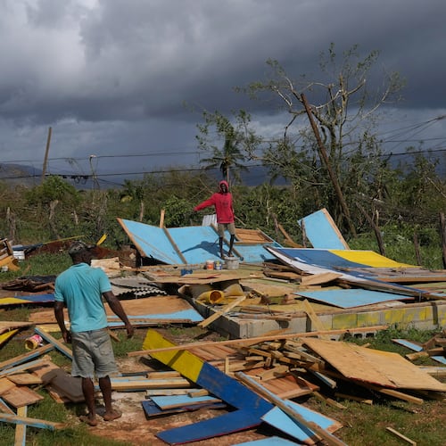 Residents stand on the wreckage of a house destroyed by Hurricane Melissa in Santa Cruz, Jamaica, Wednesday, Oct. 29, 2025. (AP Photo/Matias Delacroix)