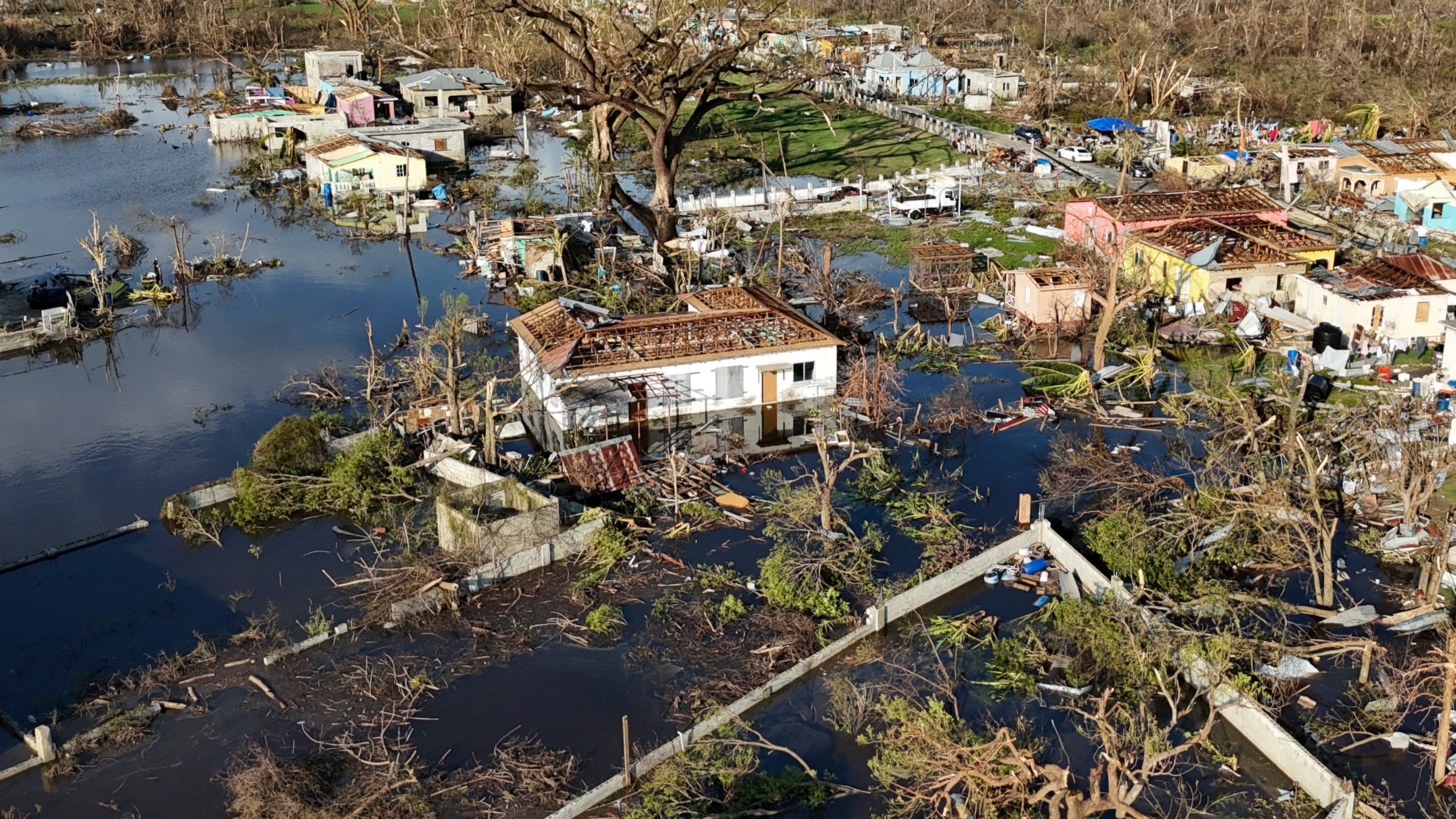 FILE - Debris surrounds damaged homes along the Black River, Jamaica, Thursday, Oct. 30, 2025, in the aftermath of Hurricane Melissa. (AP Photo/Matias Delacroix, File)