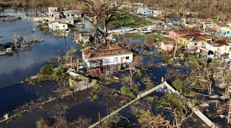 FILE - Debris surrounds damaged homes along the Black River, Jamaica, Thursday, Oct. 30, 2025, in the aftermath of Hurricane Melissa. (AP Photo/Matias Delacroix, File)