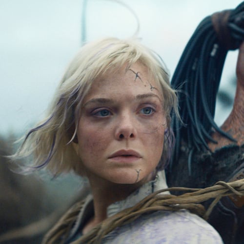 This image released by 20th Century Studios shows Thia, portrayed by Elle Fanning, left, and Dek, portrayed by Dimitrius Schuster-Koloamatangi, in a scene from "Predator: Badlands." (20th Century Studios/Disney via AP)
