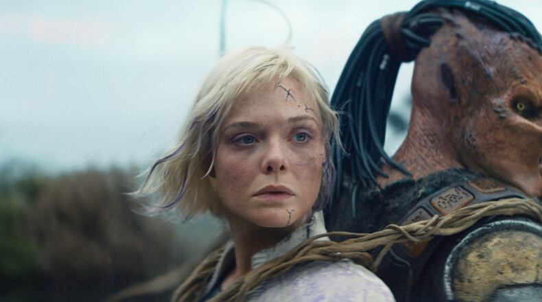 This image released by 20th Century Studios shows Thia, portrayed by Elle Fanning, left, and Dek, portrayed by Dimitrius Schuster-Koloamatangi, in a scene from "Predator: Badlands." (20th Century Studios/Disney via AP)
