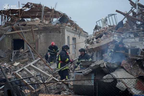 In this photo provided by the Ukrainian Emergency Service, firefighters search for victims following a Russian air attack in Khmelnytskyi region, Ukraine, Sunday, May 25, 2025. (Ukrainian Emergency Service via AP)
