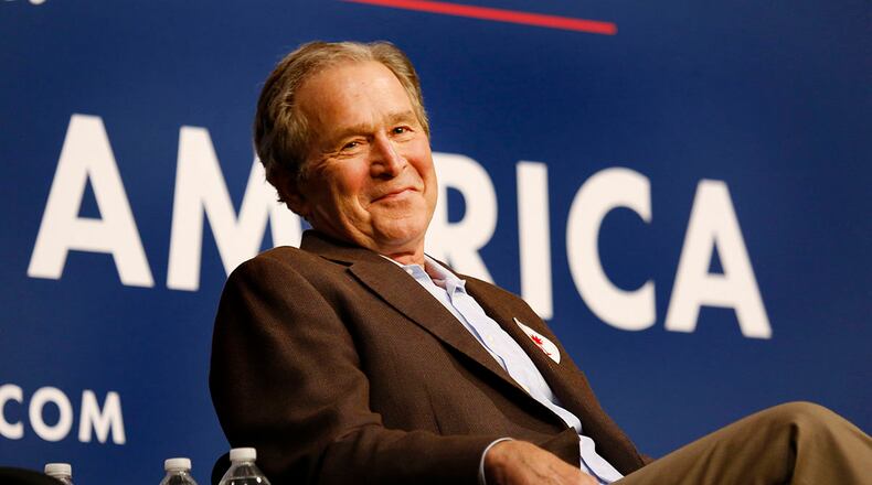 Former President George W. Bush campaigns with his brother, Republican presidential candidate Jeb Bush. "... We do not need somebody in the Oval Office who mirrors and inflames our anger and frustration," he told the crowd. Carolyn Cole / Los Angeles Times