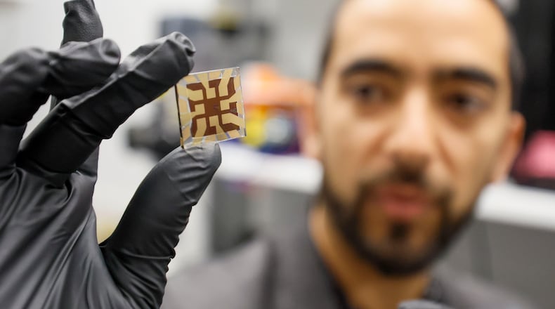 Juan-Pablo Correa-Baena shows a finished solar chip made with perovskite in one of the laboratories inside the Pettit Microelectronics building at Georgia Tech on Wednesday, March 12, 2025. Georgia Tech’s lab has made a breakthrough in solar technology. They have improved perovskite’s durability, an alternative to the silicon-based cells found in most solar panels. (Miguel Martinez/AJC)