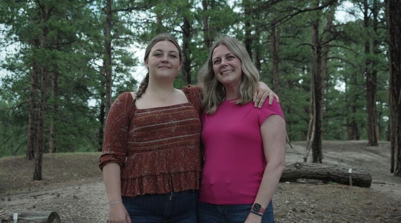 Charlotte Touzalin stands with her mother, Anne Schultz, Friday, July 10, 2026 in Elizabeth, Colo. (AP Photo/Brittany Peterson)