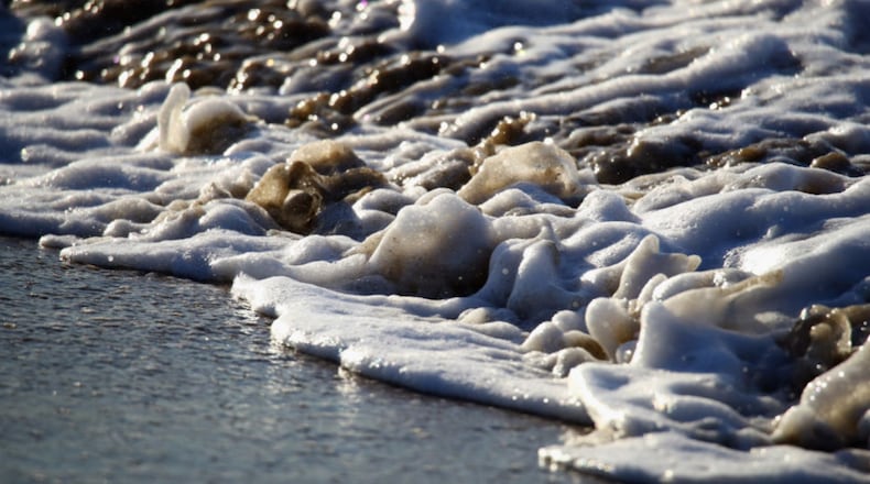 A closeup on waves hitting the beach. A man drowned while rescuing six children from a fast-moving currents. (Photo by Bruce Bennett/Getty Images)