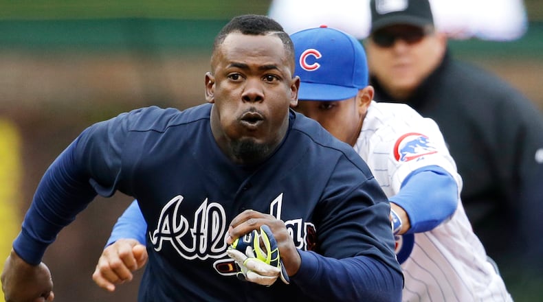 Atlanta Braves' Adonis Garcia is tagged out by Chicago Cubs shortstop Addison Russell during the sixth inning of a baseball game, Sunday, May 1, 2016, in Chicago. (AP Photo/Nam Y. Huh)