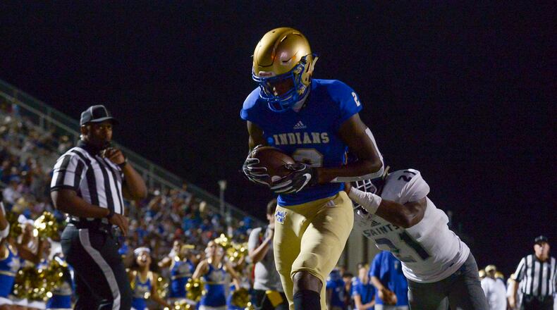 McEachern wide receiver Dacari Collins (2) runs the ball for a touchdown as Cedar Grove cornerback Tee Denson (21) tries to stop him early in the first half of Friday's game at McEachern. (Daniel Varnado/Special)