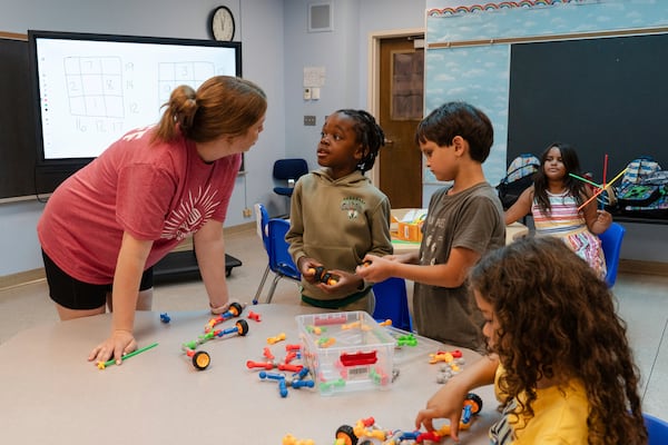 Children play with building blocks before participating in math activities during the East Providence Boys and Girls Club Summer Camp at Emma G. Whiteknact Elementary School on Thursday, July 10, 2025, in Providence R.I. (AP Photo/Sophie Park)
