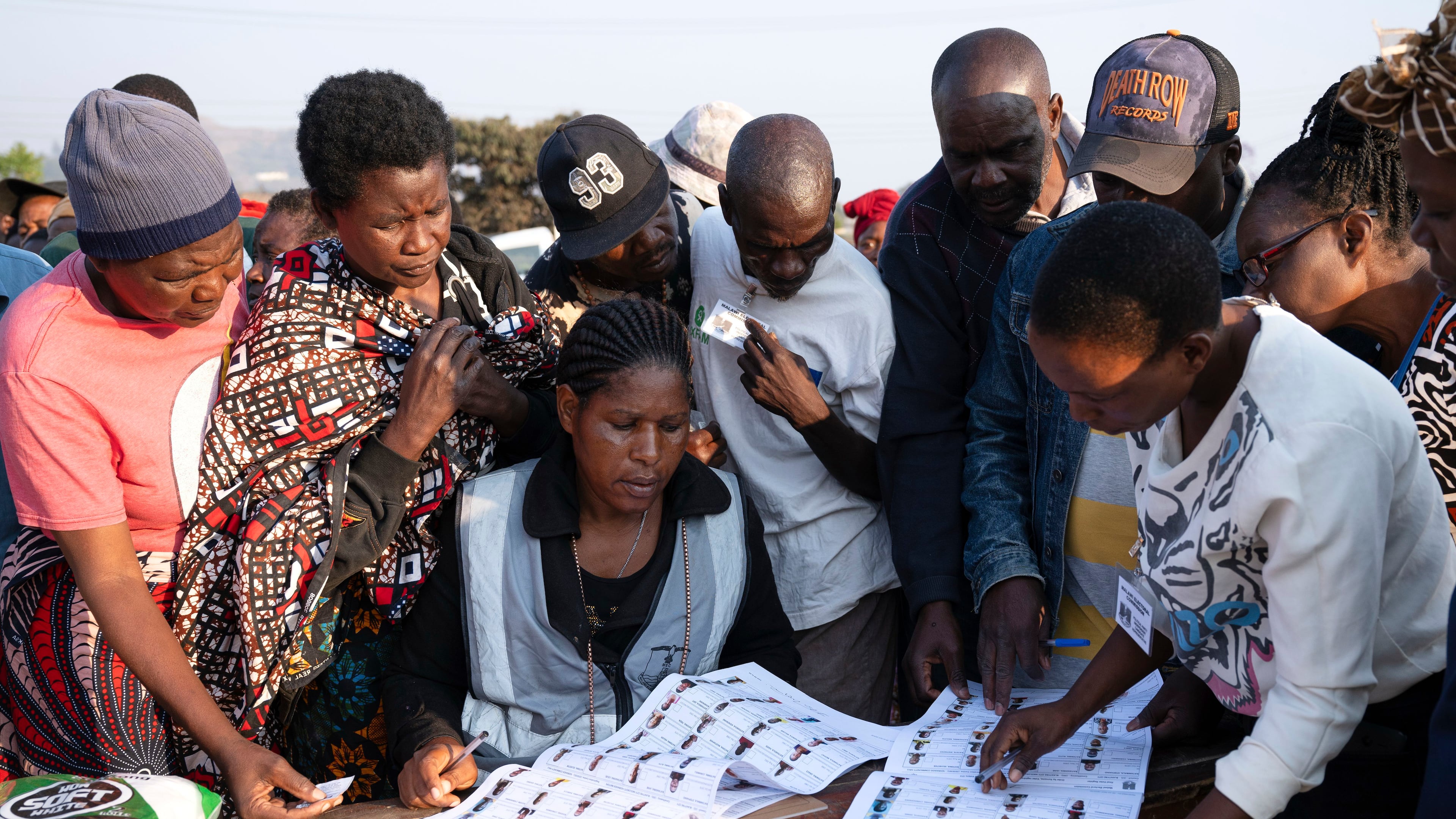 Election worker check names from electoral rolls at a polling station in Blantyre, Malawi, Tuesday, Sept. 16, 2025. (AP Photo/Thoko Chikondi)
