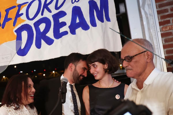Democratic mayoral candidate Zohran Mamdani, center left, appears on stage with his wife, Rama, mother, Mira Nair Duwaji, left, and father, Mahmood Mamdani, at his primary election party, in New York, Wednesday, June 25, 2025. (AP Photo/Heather Khalifa)