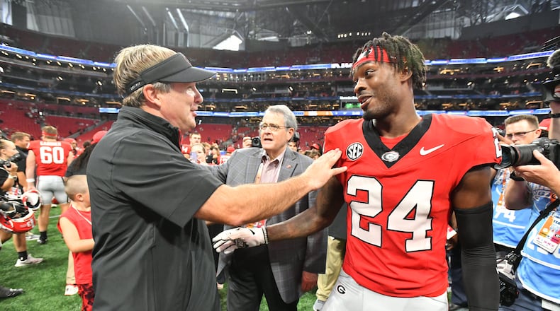 Georgia head coach Kirby Smart congratulates Georgia defensive back Malaki Starks after Georgia beat Clemson during an NCAA football game at Mercedes-Benz Stadium on Saturday, Aug. 31, 2024, in Atlanta. Three Bulldogs went in the first round of Thursday's NFL draft. (Hyosub Shin/AJC)