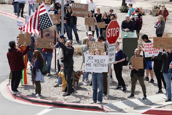People protest before a press conference about Utah's new fluoride ban, food additives and SNAP funds legislation with Health and Human Services Secretary Robert F. Kennedy Jr., Monday, April 7, 2025, in Salt Lake City. (AP Photo/Melissa Majchrzak)