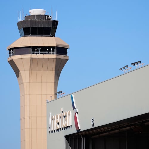 FILE - A control tower by an American Airlines hangar is shown at Dallas Fort Worth International Airport, Oct. 15, 2025, in DFW Airport, Texas. (AP Photo/Tony Gutierrez, file)
