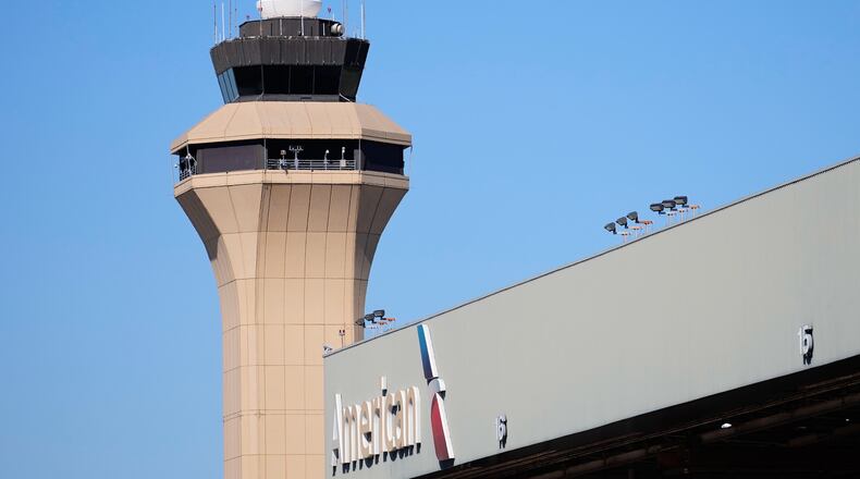 FILE - A control tower by an American Airlines hangar is shown at Dallas Fort Worth International Airport, Oct. 15, 2025, in DFW Airport, Texas. (AP Photo/Tony Gutierrez, file)