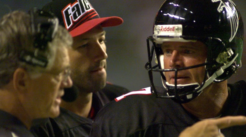 Then Falcons backup quarterback Steve DeBerg, who came out of retirement at the age of 44 in 1998, consults with head coach Dan Reeves and quarterback Chris Chandler on the sideline of a game. DeBerg is the oldest quarterback to ever start an NFL game and oldest to be on a Super Bowl roster.