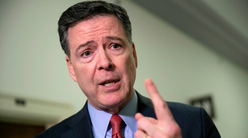 FILE - Former FBI Director James Comey speaks to reporters on Capitol Hill in Washington, Dec. 17, 2018. (AP Photo/J. Scott Applewhite, File)