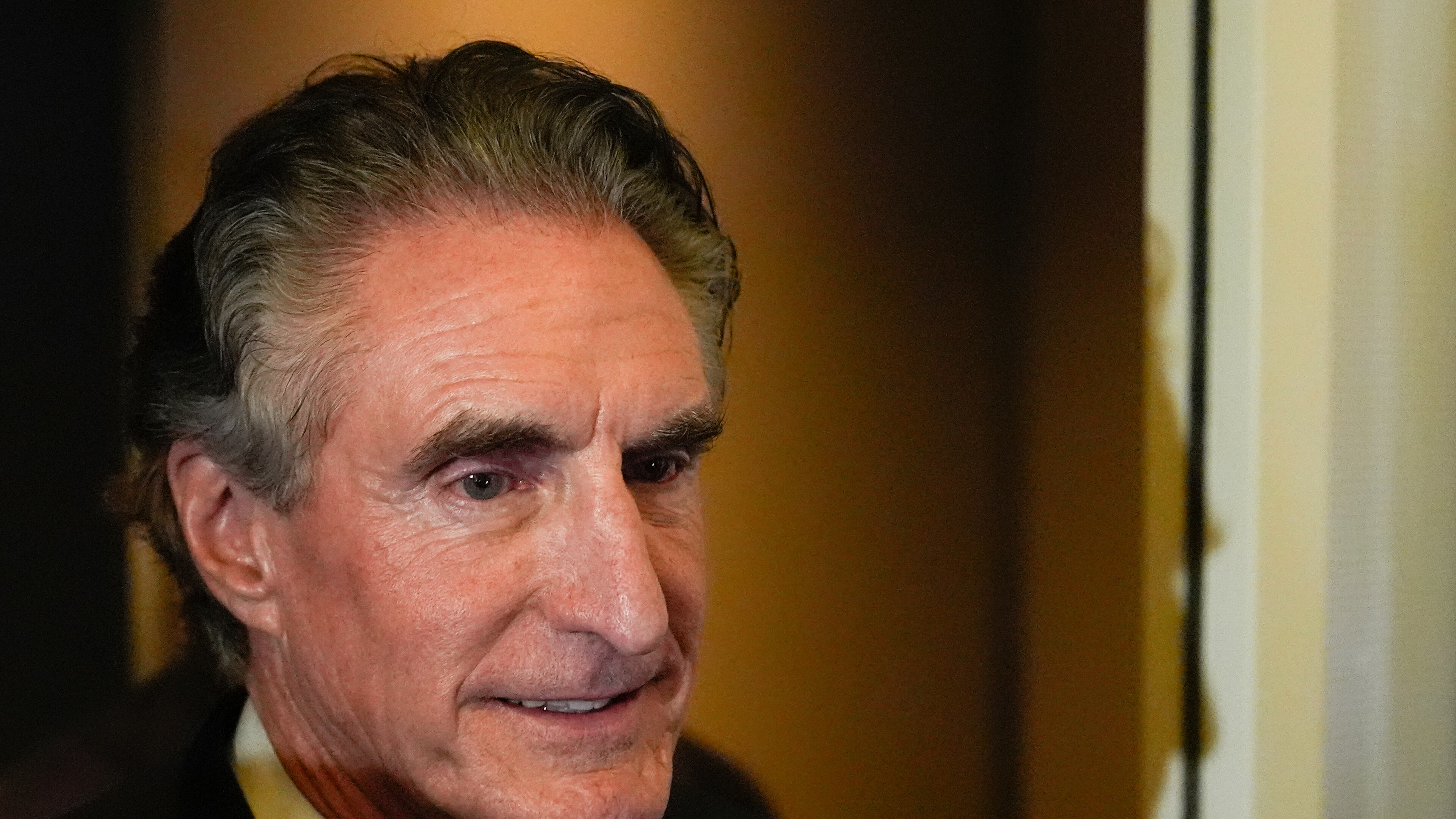 Interior Secretary Doug Burgum watches as President Donald Trump speaks to reporters aboard Air Force One while en route to Joint Base Andrews, Md. after attending a memorial for conservative activist Charlie Kirk in Glendale, Ariz., Sunday, Sept. 21, 2025. (AP Photo/Julia Demaree Nikhinson)