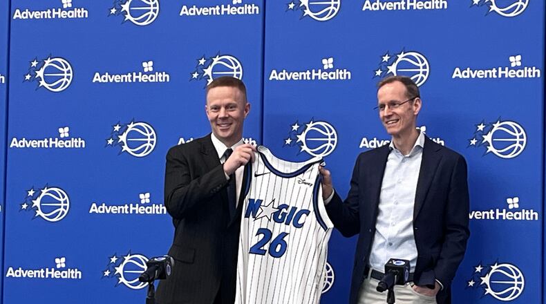 New Orlando Magic coach Sean Sweeney, left, is introduced by Magic president Jeff Weltman at a news conference at the team's training facility Thursday, June 18, 2026, in Orlando, Fla. (AP Photo/Tim Reynolds)