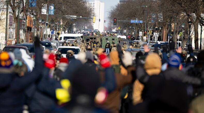 Protesters advance toward federal agents with their hands up near the site of the fatal shooting of 37-year-old Alex Pretti by federal agents in Minneapolis on Saturday, Jan. 24, 2026. (Ellen Schmidt/MinnPost via AP)