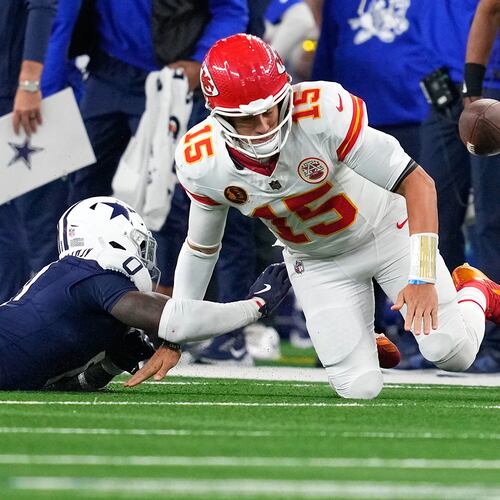 Dallas Cowboys linebacker DeMarvion Overshown, left, knocks the ball out of bounds away from Kansas City Chiefs quarterback Patrick Mahomes during the first half of an NFL football game Thursday, Nov. 27, 2025, in Arlington, Texas. (AP Photo/Tony Gutierrez)