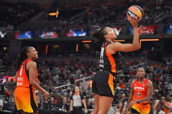 Minnesota Lynx's Napheesa Collier, right, shoots against Indiana Fever's Kelsey Mitchell during the second half of a WNBA All-Star basketball game, Saturday, July 19, 2025, in Indianapolis. (AP Photo/Michael Conroy)