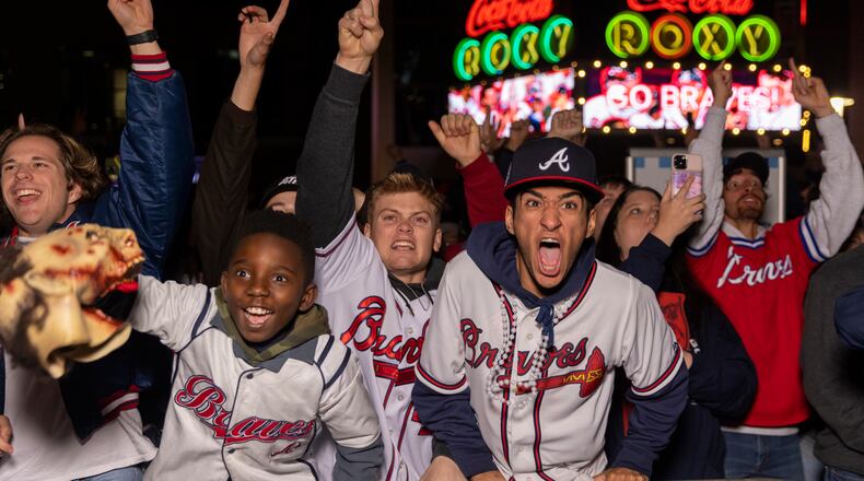 Braves fans react to Freddie Freeman hitting a home run in Game 5 of the World Series at The Battery outside Truist Park.