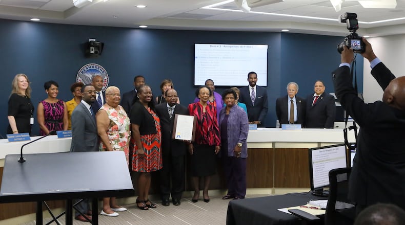 Council members and congregation members pose for a photo with Rev. P. L. Redmond, Jr., after he was honored with a proclamation presented by Council member Joyce Sheperd in August. BOB ANDRES /BANDRES@AJC.COM