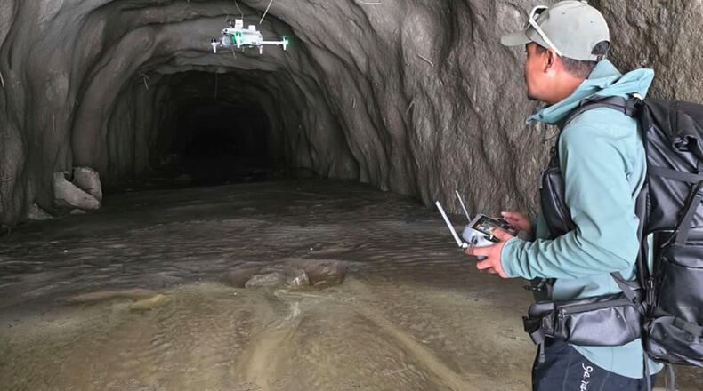 In this image provided by Manish Maharjan, filmmaker and drone pilot Manish Maharjan operates a drone at the entrance to a tunnel at the Rashuwaghadi hydropower project in Rasuwa district, Nepal, Monday, Aug. 31, 2026. (Manish Maharjan via AP)
