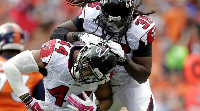 Atlanta Falcons outside linebacker Vic Beasley (44) and safety Kemal Ishmael (36) celebrate a stop during the second half of an NFL football game against the Denver Broncos, Sunday, Oct. 9, 2016, in Denver. (AP Photo/Joe Mahoney)