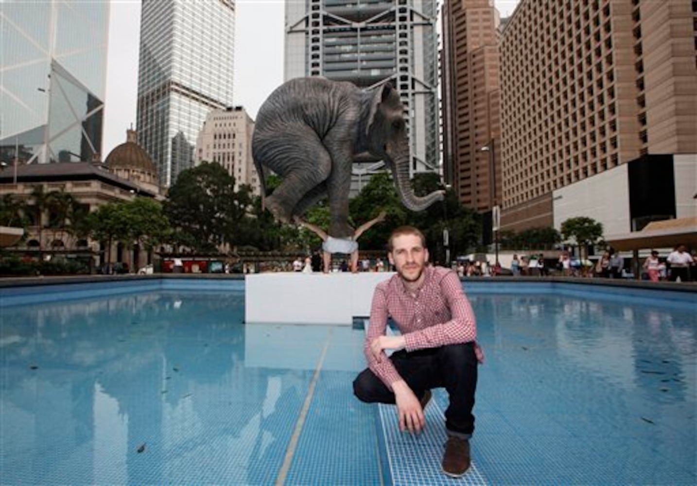 Statue of man balancing elephant