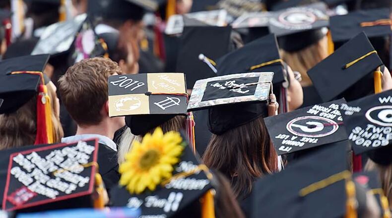 University of Georgia students personalized their mortar boards during 2019 spring undergraduate commencement ceremony at Sanford Stadium in Athens on Friday, May 10, 2019. The average grade-point average of its students this spring semester was 3.76, higher than 2019. HYOSUB SHIN / HSHIN@AJC.COM