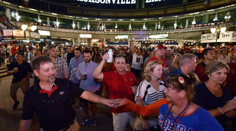 Georgia and Florida fans gather to celebrate during an annual party at the Jacksonville Landing on the eve of the Georgia vs Florida game on Friday, October 28, 2016. The city of Jacksonville is adding more activities to enhance the entertainment value of the week Georgia and Florida annually meet there to play football. HYOSUB SHIN / HSHIN@AJC.COM