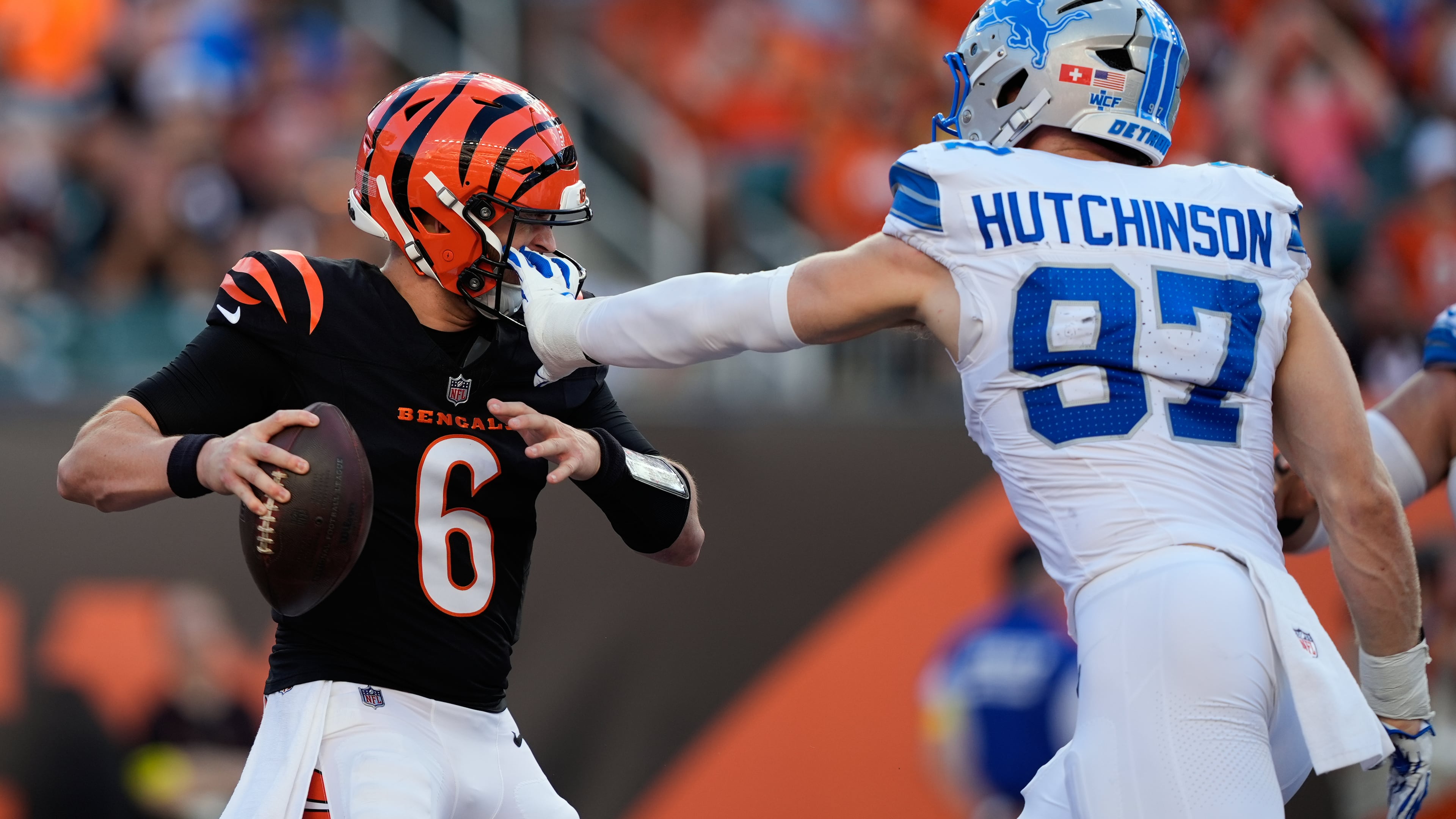 Detroit Lions defensive end Aidan Hutchinson (97) grabs Cincinnati Bengals quarterback Jake Browning (6) by the facemask during the first half of an NFL football game Sunday, Oct. 5, 2025, in Cincinnati. (AP Photo/Carolyn Kaster)