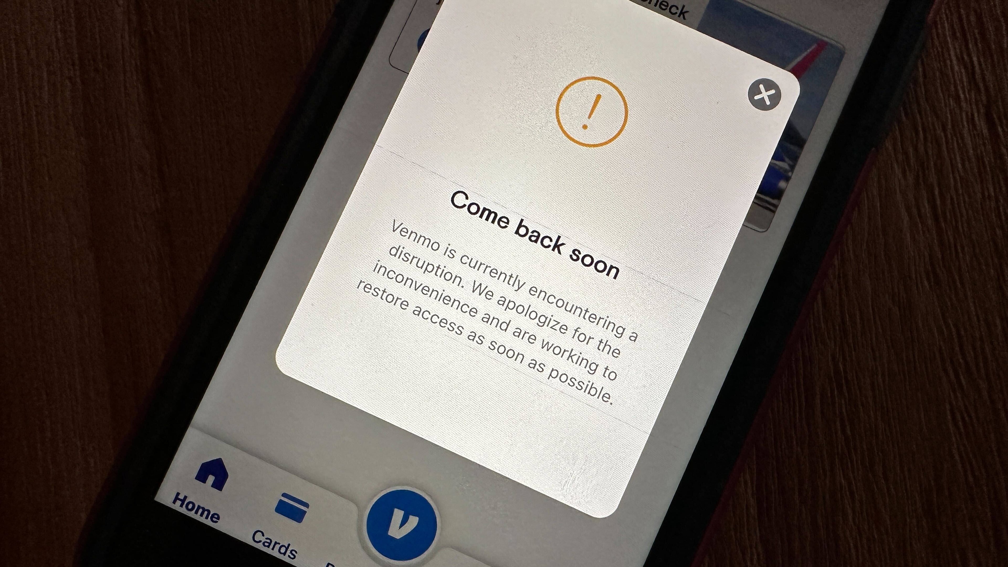 A cell phone screen shows the Venmo app informing users of a service disruption in Honolulu, Hawaii, on Wednesday, Dec. 3, 2025. (AP Photo/Audrey McAvoy)