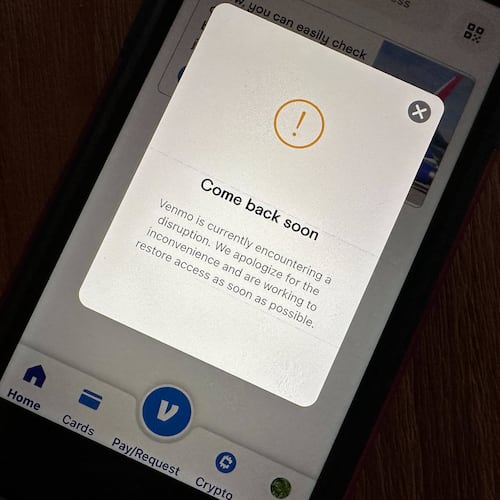 A cell phone screen shows the Venmo app informing users of a service disruption in Honolulu, Hawaii, on Wednesday, Dec. 3, 2025. (AP Photo/Audrey McAvoy)