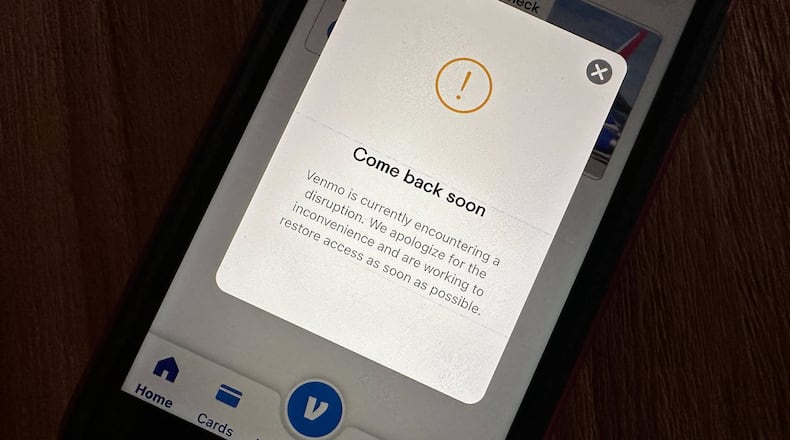 A cell phone screen shows the Venmo app informing users of a service disruption in Honolulu, Hawaii, on Wednesday, Dec. 3, 2025. (AP Photo/Audrey McAvoy)