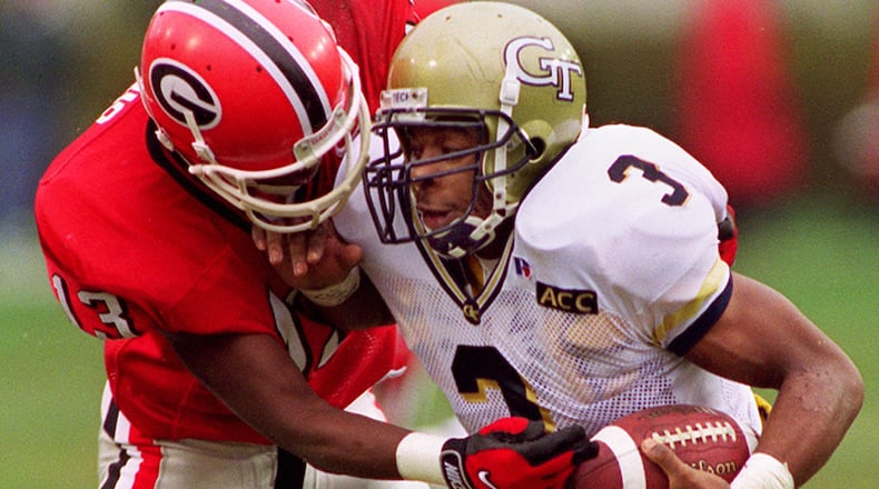 Tech running back Charlie Rogers tries to elude the grasp of Georgia's Jeff Harris during the Bulldogs' 27-24 win over the rival Jackets in 1997. The win was Georgia's seventh consecutive win in the series.