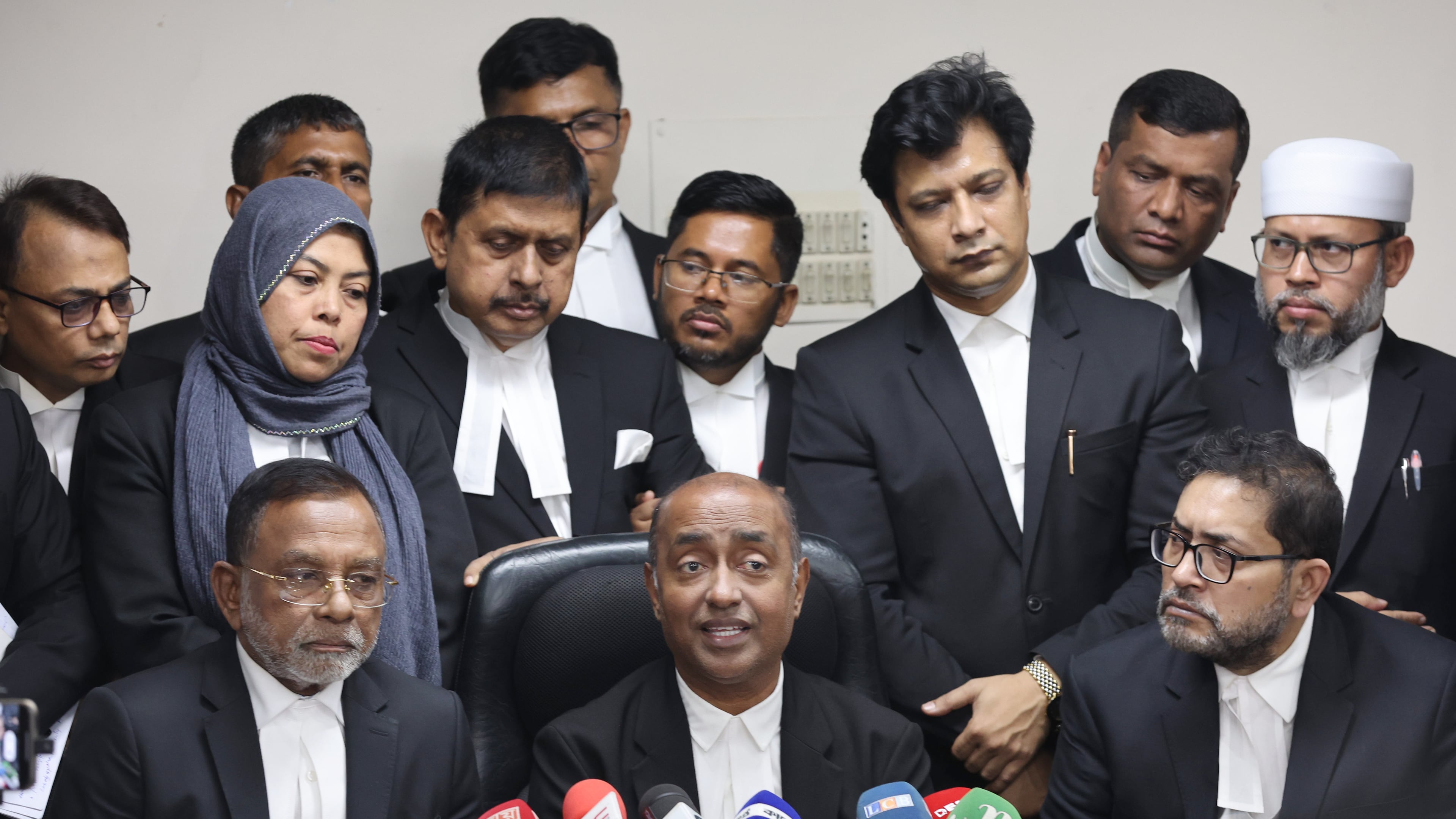 Bangladesh Attorney General Md Asaduzzaman, center sitting, and senior lawyers address a press conference after Supreme Court restored a nonpartisan caretaker government system for national elections but said it won't apply to the polls being held early next year, in Dhaka, Bangladesh, Thursday, Nov. 20, 2025. (AP Photo/Abdul Goni)
